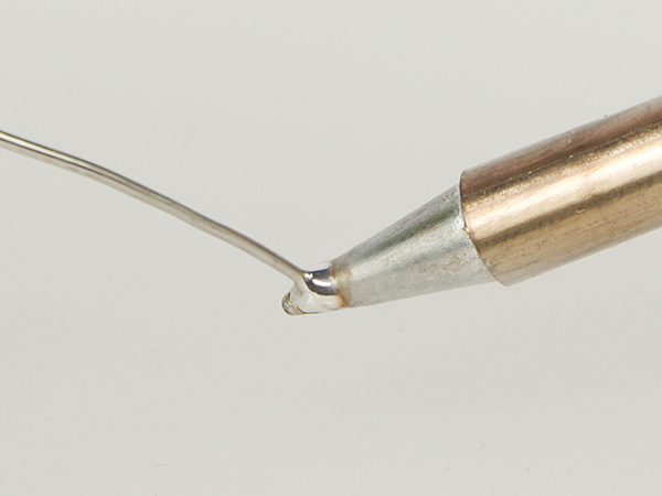 Feed solder to the tip and see whether or not solder wets on it.